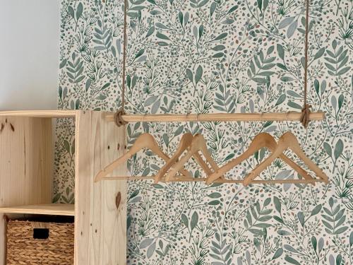 a room with a wall with green and white wallpaper at Cocon de douceur en centre ville in Le Puy-en-Velay