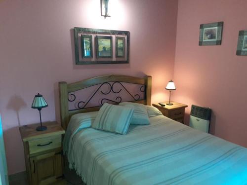 a bedroom with a bed and two night stands with two lamps at MyM in Costa Azul