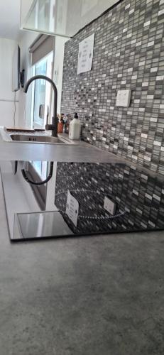 a kitchen with a sink and a counter with a sink at Holly's Flat Close to Ferry And EV in Wellington
