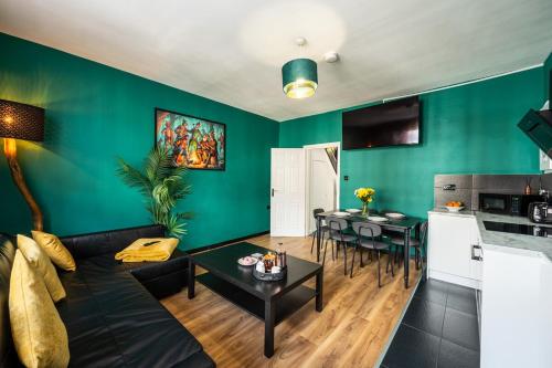 a living room with a couch and a table at Spacious 4-Bed Apartment · Sleeps 6 · City Centre in Nottingham