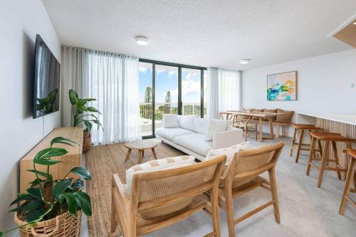 a living room with a couch and a table at Coolum Beach Retreat in Coolum Beach