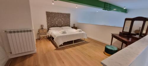a bedroom with a bed and a table and a mirror at La Dimora del Cardinale in Naples