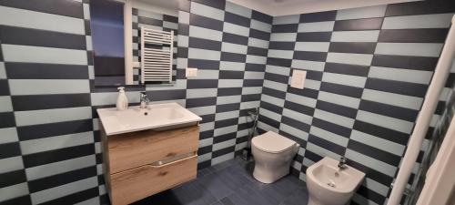 a black and white bathroom with a sink and a toilet at La Dimora del Cardinale in Naples