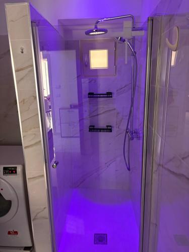 a bathroom with a shower with purple lighting at Casa del maresciallo in Giovinazzo