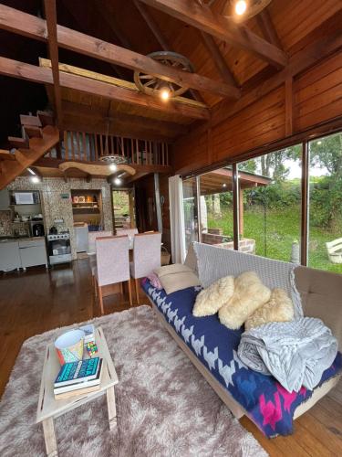 a living room with a couch and a table at Cabana Gehrke in Nova Petrópolis
