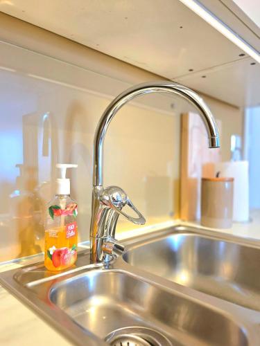 a sink with a faucet in a kitchen at Fygle living in Vestvågøya