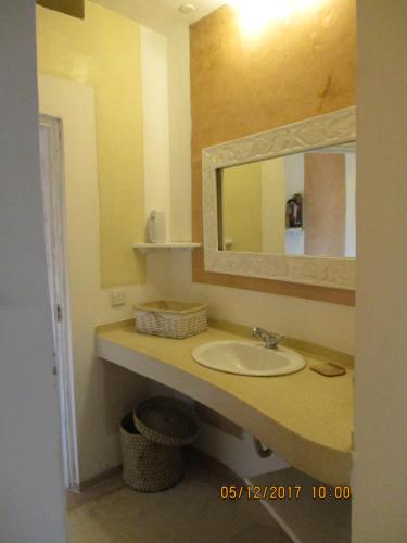 a bathroom with a sink and a mirror at Lady D House Watamu in Watamu