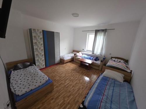 a small room with two beds and a couch at Matei Apartament in Tîrnăveni