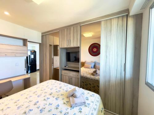 a bedroom with a bed and a television in a room at Frente mar na praia de Itaparica! in Vila Velha