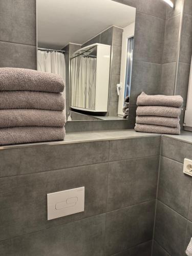a bathroom with a mirror and some towels at Premium Apartment near Cologne in Hürth