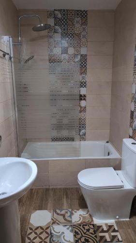 a bathroom with a tub and a toilet and a sink at Apartamento Turístico Monteceli AT-CC-00748 in Gata