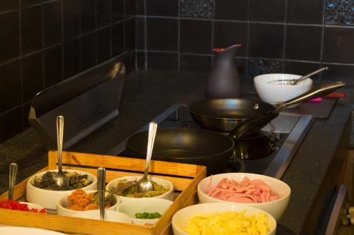 a kitchen counter with bowls of food on a stove at Historico Central Hotel in Mexico City