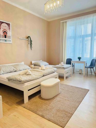 a bedroom with a large bed and a living room at Ostrava Apartment in Ostrava