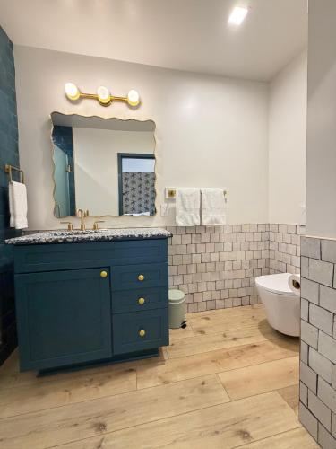 a bathroom with a blue sink and a mirror at The Breeze Beachfront Resort in Surfside Beach