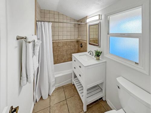 a white bathroom with a sink and a shower at F-20 Paradise Pier in Anaheim