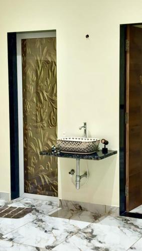 a bathroom with a sink on a wall at Aarambh Villa in Sātirje