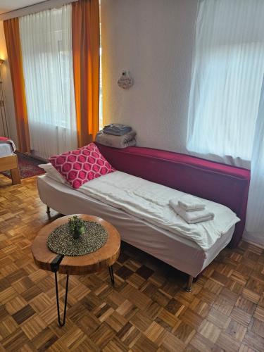 a small room with a bed and a table at Happy apartment-OldTown Sarajevo in Sarajevo