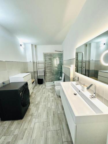 a bathroom with two sinks and a toilet and a mirror at Villa Felix in Omegna
