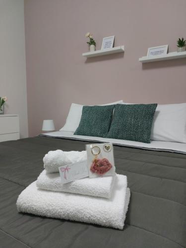 a bedroom with a bed with towels on it at Il cuore di Lavika in Acireale