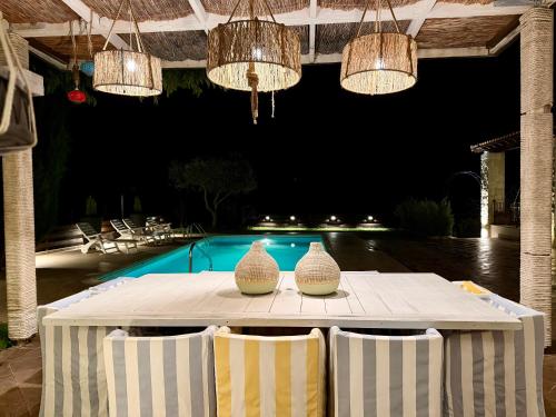two vases are sitting on a table with chairs at Villa Grand Zeus in Anoyira