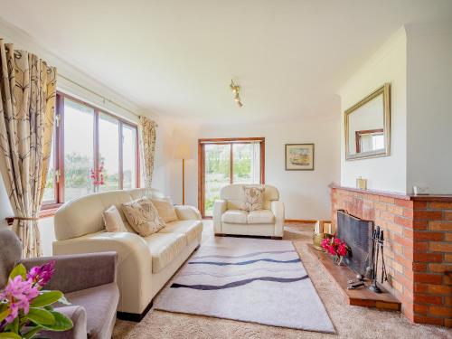 a living room with two couches and a fireplace at Glenview in Appin