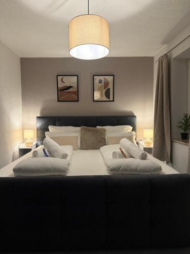 a bedroom with a large bed with two pillows at MarktQuartier Bad Schandau in Bad Schandau
