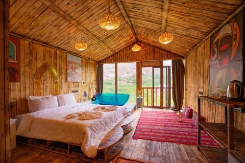 a bedroom with a large bed in a room at Riad Atlas Bangalow in Imlil