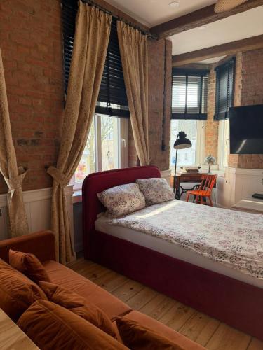 a bedroom with a bed and a brick wall at Apartments PSD - Filmowa in Słupsk