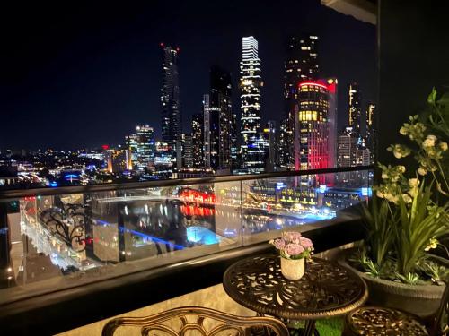 a view of a city skyline at night from a balcony at Breathtaking views of Yarra River and City skyline with Gym access in Melbourne