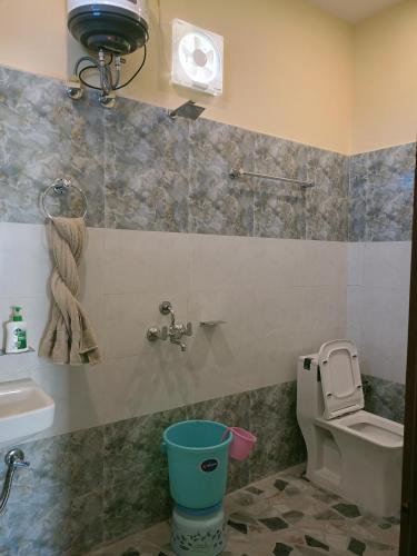 a bathroom with a toilet and a sink at Chill with pahadi in Lansdowne