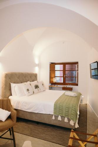 a bedroom with a large bed and a window at Eleven, Boutique luxury house & garden in Boliqueime