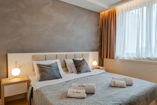 a bedroom with a large bed with two pillows at Z terme Harmony in Vrnjačka Banja