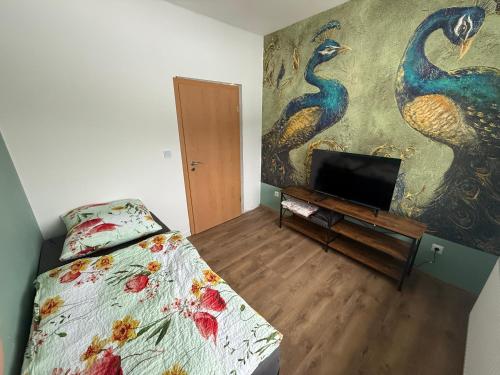 a bedroom with a bed and a painting on the wall at Schelder Zimmer in Dillenburg