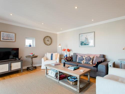 a living room with a couch and a table at 16 Marinus in Cowes