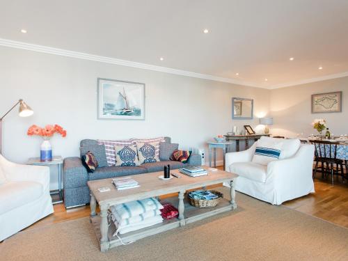 a living room with a couch and a table at 16 Marinus in Cowes