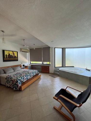 a bedroom with a bed and a desk and a chair at Residencia privada de 10 habitaciones para 20 personas in Chiconcuac