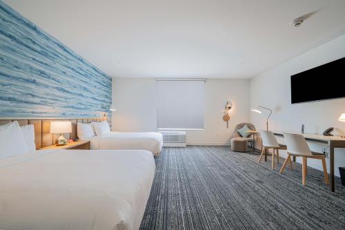 a hotel room with two beds and a desk at TownePlace Suites Longview in Longview