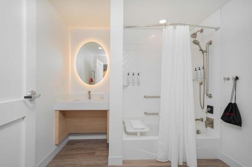a white bathroom with a shower and a sink at TownePlace Suites Longview in Longview