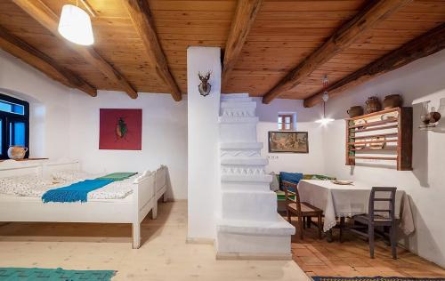 a bedroom with a bed and a table and a table and chairs at NohaTerény in Terény