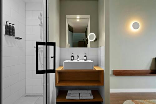 a bathroom with a sink and a shower at Residence Inn by Marriott Amsterdam Schiphol Airport in Badhoevedorp