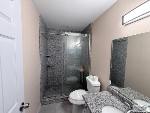 a bathroom with a shower and a toilet and a sink at 305 Calle Amistosa in Brownsville