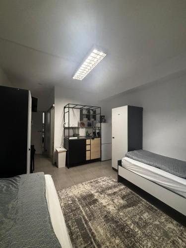 a bedroom with a bed and a room with a refrigerator at Monteur Boardinghouse WorkHomes Zuffenhausen in Stuttgart
