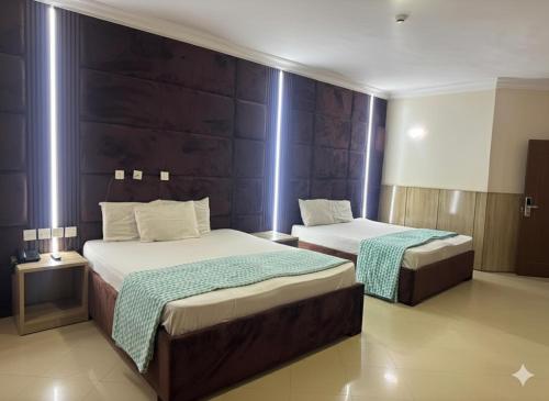 a hotel room with two beds in a room at DE-George's Grand Resort in Mama