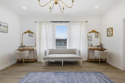 a living room with a couch and two mirrors at The Lake Charles Charmer in Lake Charles