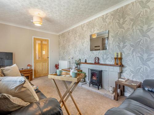 a living room with a fireplace and a couch at Tanera in Wick