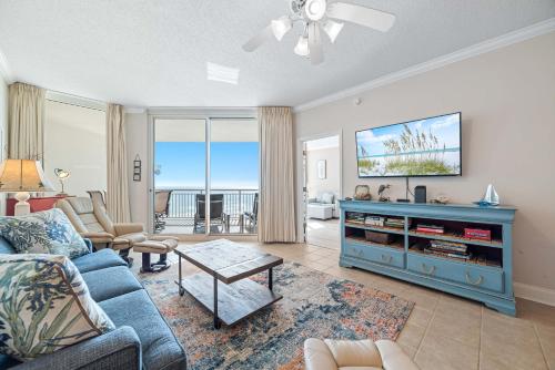 a living room with a couch and a tv at Palacio Unit 403 in Pensacola