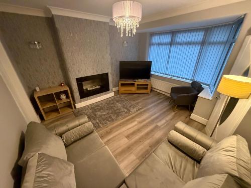 a living room with a couch and a fireplace at 2 Bed house - Brighouse close to McDonalds and B&M in Brighouse