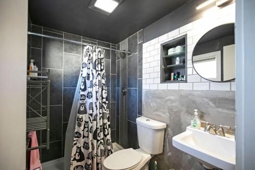 a bathroom with a toilet and a sink and a shower at Rose Park Hideaway in Missoula