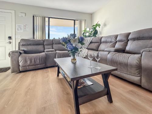 a living room with a couch and a table with wine glasses at Gather Together home in Montrose