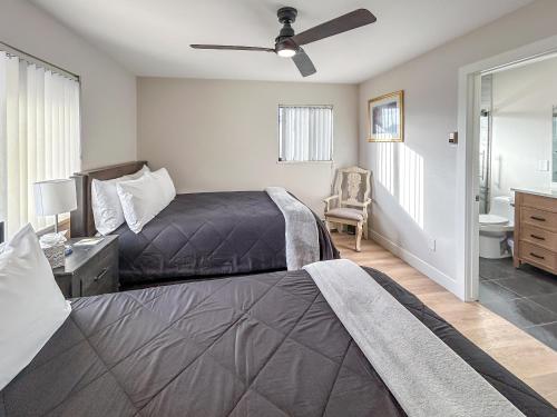 a bedroom with two beds and a ceiling fan at Gather Together home in Montrose